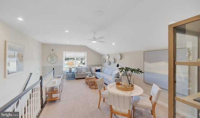 interior space featuring light colored carpet, ceiling fan, and lofted ceiling