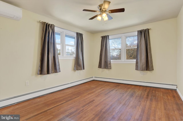 empty room featuring an AC wall unit, ceiling fan, baseboard heating, and hardwood / wood-style flooring