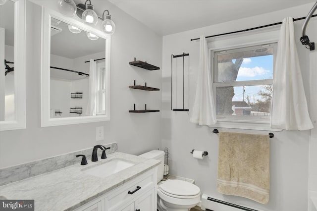 bathroom featuring vanity, toilet, and baseboard heating