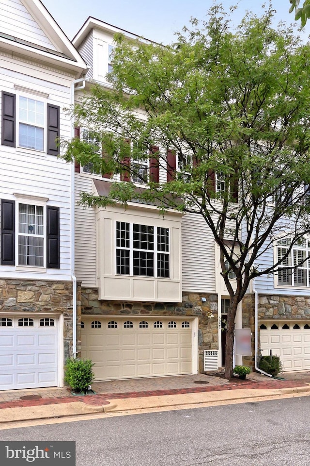 multi unit property featuring a garage