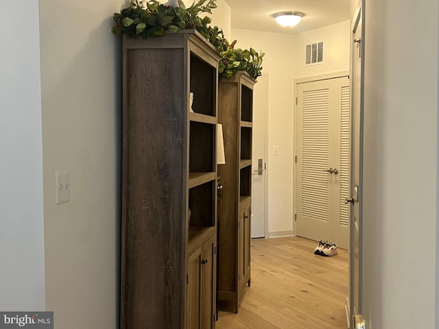 hallway with light hardwood / wood-style flooring