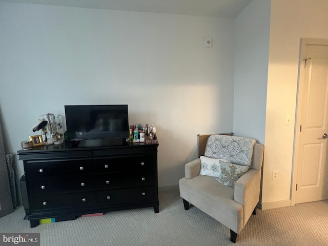 sitting room featuring light carpet