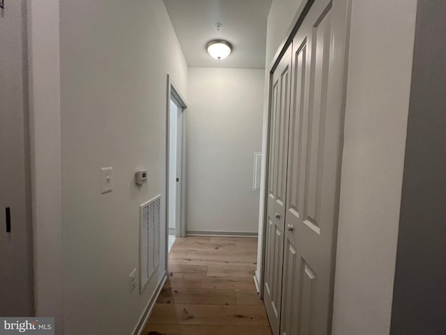 corridor with light hardwood / wood-style floors