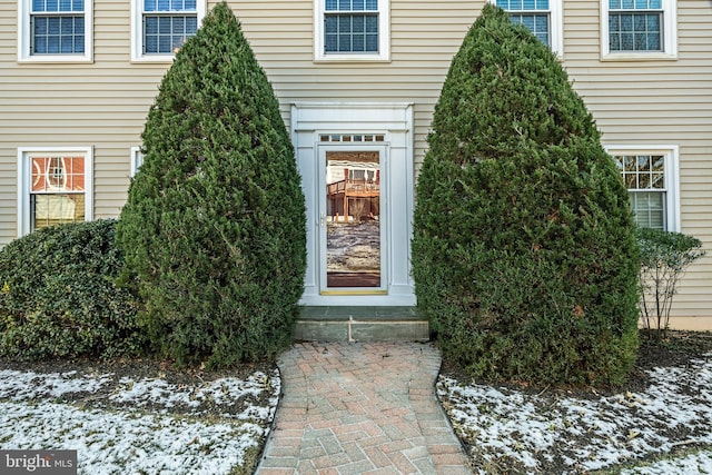 view of snow covered property entrance