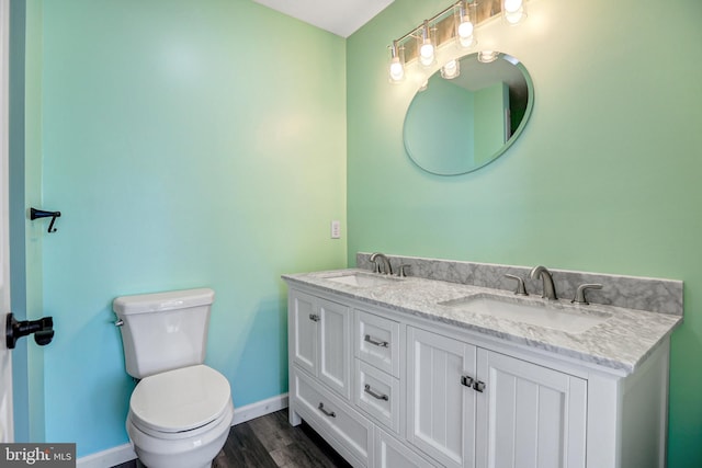 bathroom with vanity, hardwood / wood-style flooring, and toilet