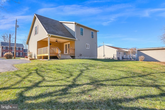 back of property with a lawn and ceiling fan