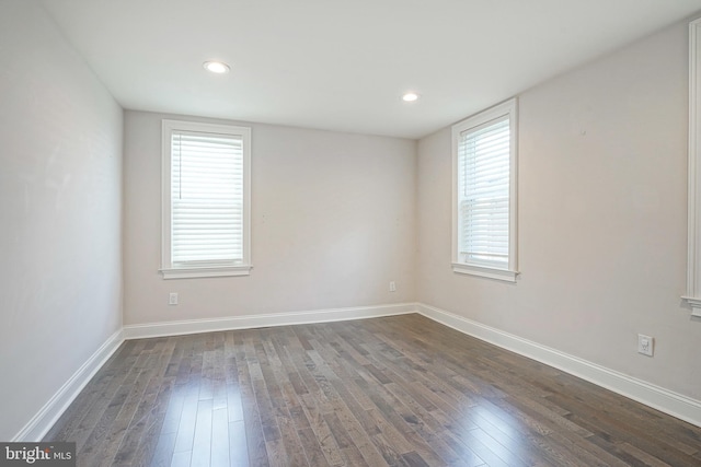 empty room with dark hardwood / wood-style floors