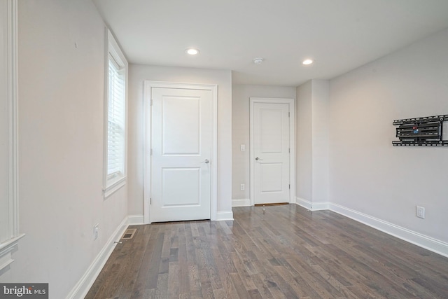 empty room featuring dark hardwood / wood-style flooring