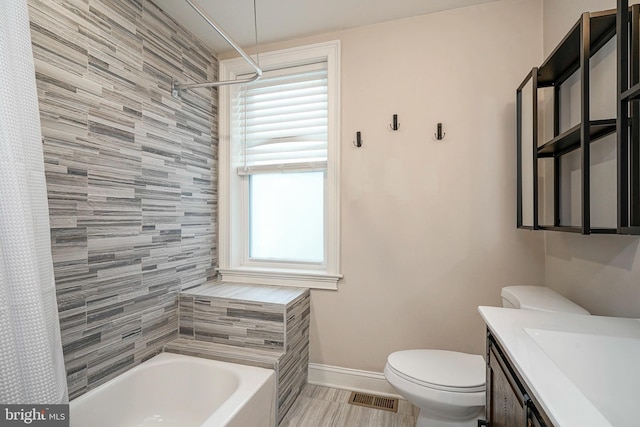 full bathroom featuring vanity, toilet, and shower / tub combo with curtain