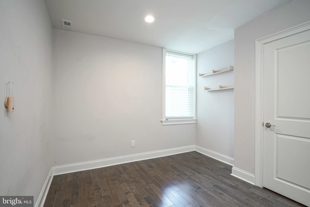 spare room featuring dark hardwood / wood-style floors