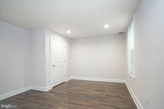 empty room with dark hardwood / wood-style flooring