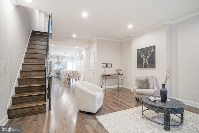 interior space with hardwood / wood-style floors and crown molding