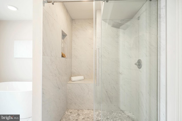 bathroom with separate shower and tub