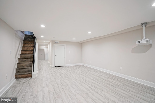 basement with light hardwood / wood-style floors