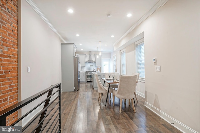 dining space with crown molding, dark wood-type flooring, and sink