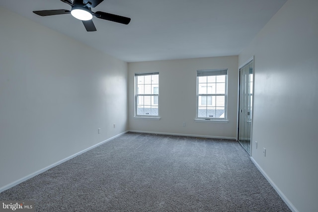 spare room with ceiling fan and carpet floors