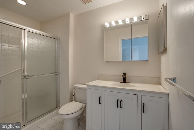 bathroom featuring tile patterned flooring, vanity, an enclosed shower, and toilet