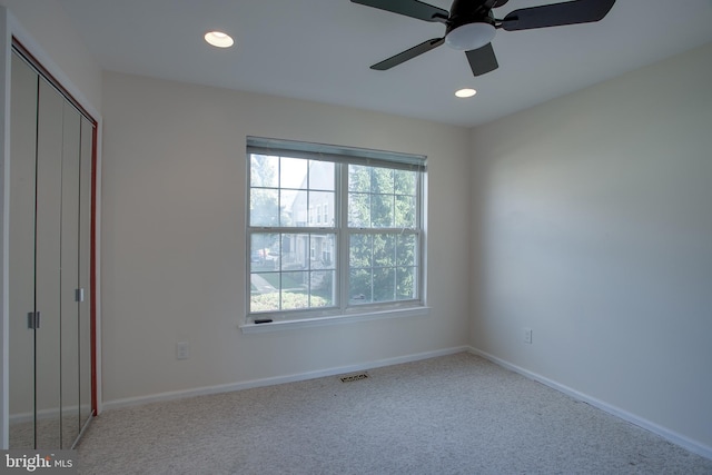 interior space featuring light colored carpet and ceiling fan