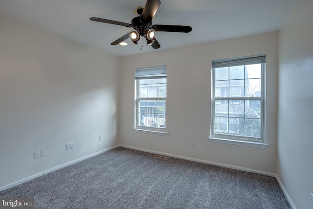 spare room with carpet and ceiling fan