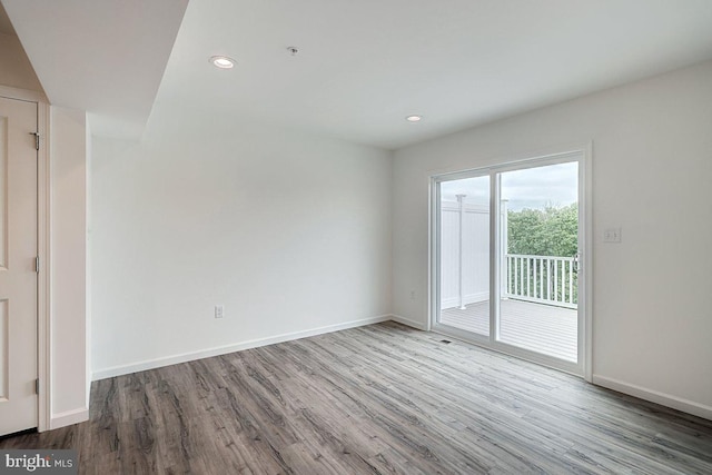 empty room with hardwood / wood-style flooring