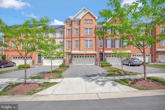 townhome / multi-family property featuring solar panels