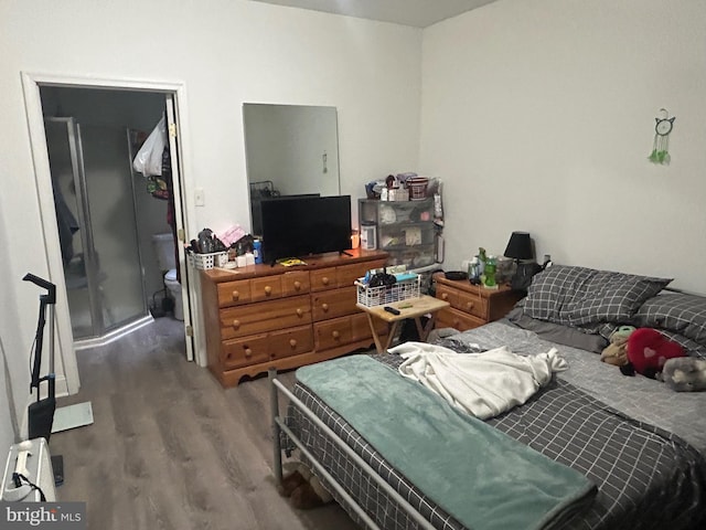 bedroom with hardwood / wood-style flooring