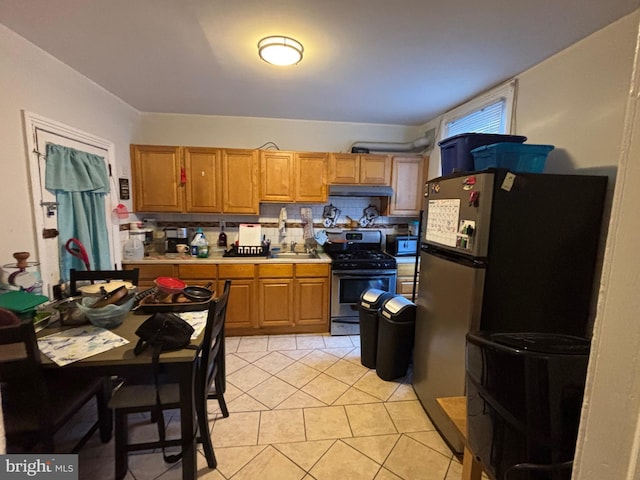 kitchen featuring light tile patterned flooring, stainless steel appliances, sink, and backsplash