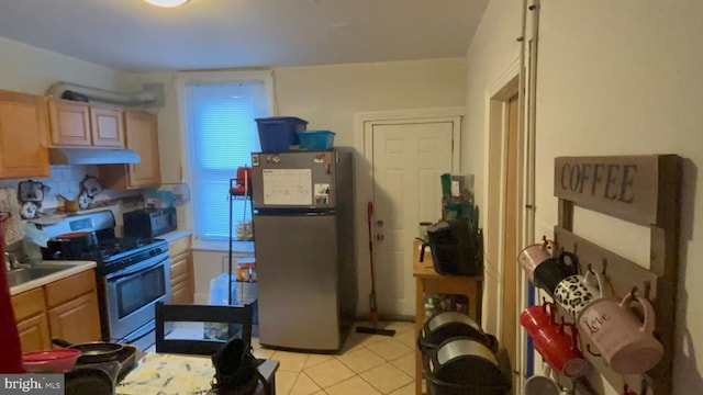 kitchen with light tile patterned floors and appliances with stainless steel finishes