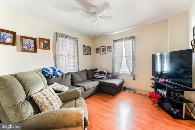 living room with ceiling fan and wood-type flooring