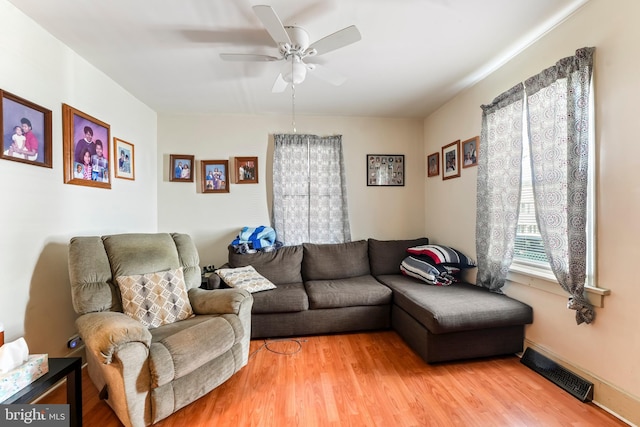 living room featuring hardwood / wood-style flooring and ceiling fan