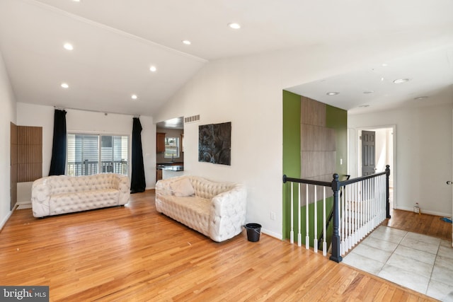 living room with light wood-type flooring, visible vents, baseboards, and recessed lighting