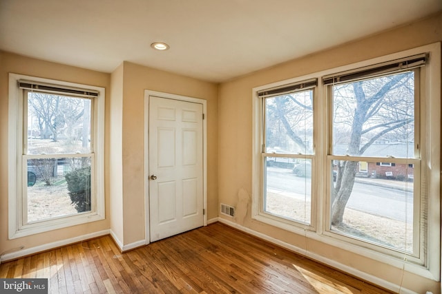 doorway to outside featuring recessed lighting, visible vents, baseboards, and wood finished floors