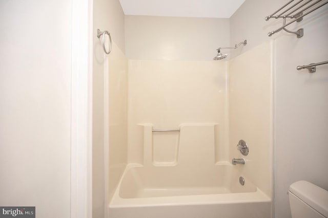 bathroom featuring shower / bathing tub combination and toilet