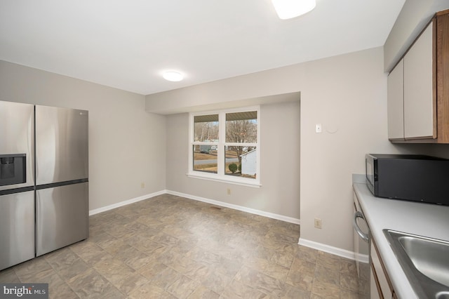 kitchen featuring white cabinetry, stainless steel fridge with ice dispenser, and sink