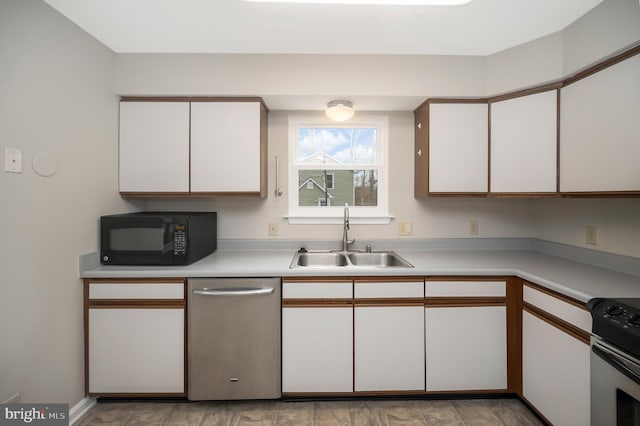 kitchen featuring stainless steel appliances, white cabinetry, and sink