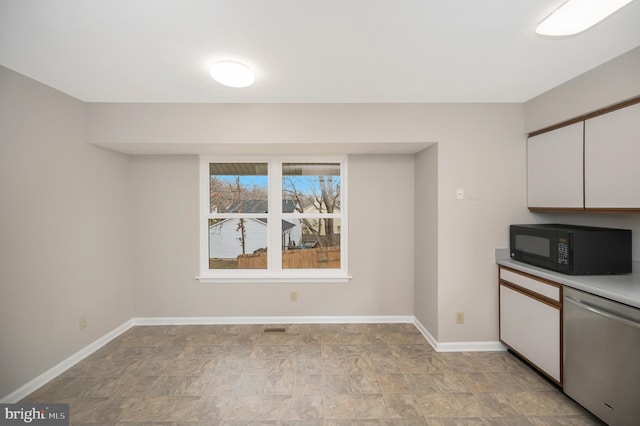 kitchen featuring white cabinets and stainless steel dishwasher