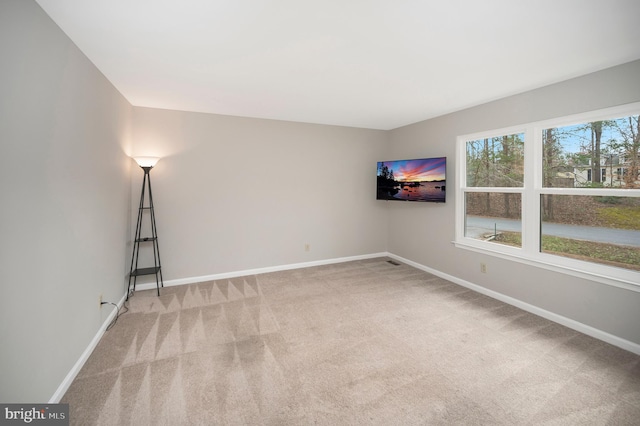 unfurnished room featuring light colored carpet