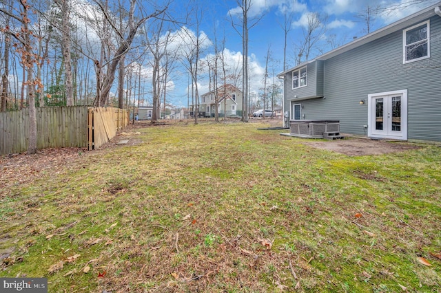 view of yard with central AC unit and french doors