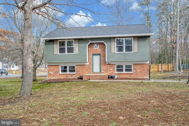 split foyer home with a front lawn