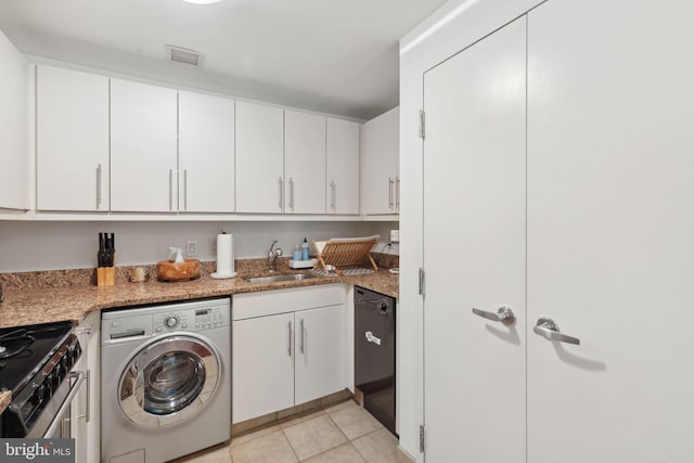 clothes washing area with washer / clothes dryer, light tile patterned floors, and sink