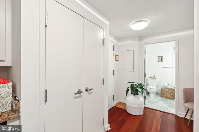 hallway with dark hardwood / wood-style flooring