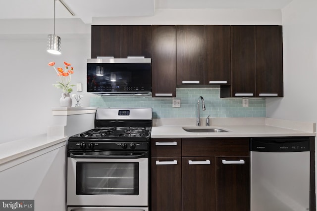 kitchen featuring sink, stainless steel appliances, tasteful backsplash, pendant lighting, and dark brown cabinets