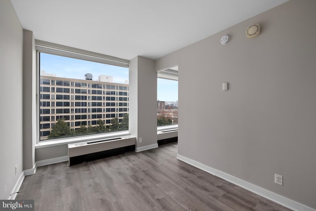 unfurnished room featuring hardwood / wood-style floors