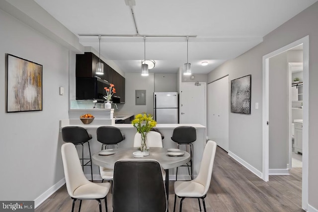 dining room featuring wood-type flooring and electric panel