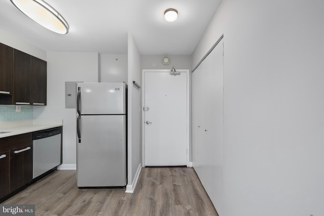 kitchen with dishwasher, white refrigerator, decorative backsplash, and dark brown cabinets