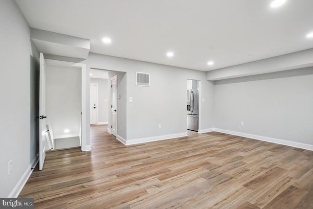 interior space with stainless steel refrigerator with ice dispenser and light hardwood / wood-style floors