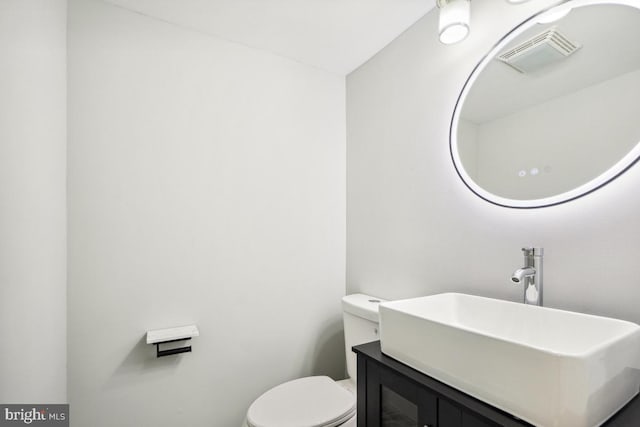 bathroom with vanity and toilet