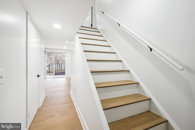 stairs featuring wood-type flooring