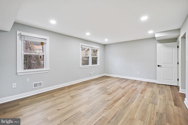 spare room featuring light hardwood / wood-style floors and a wealth of natural light