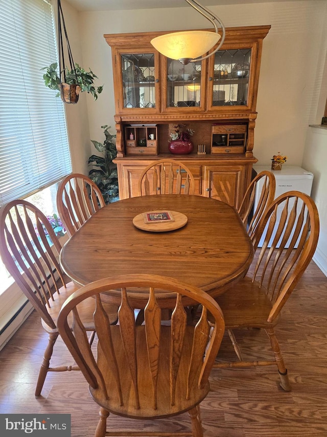 dining area with dark hardwood / wood-style flooring